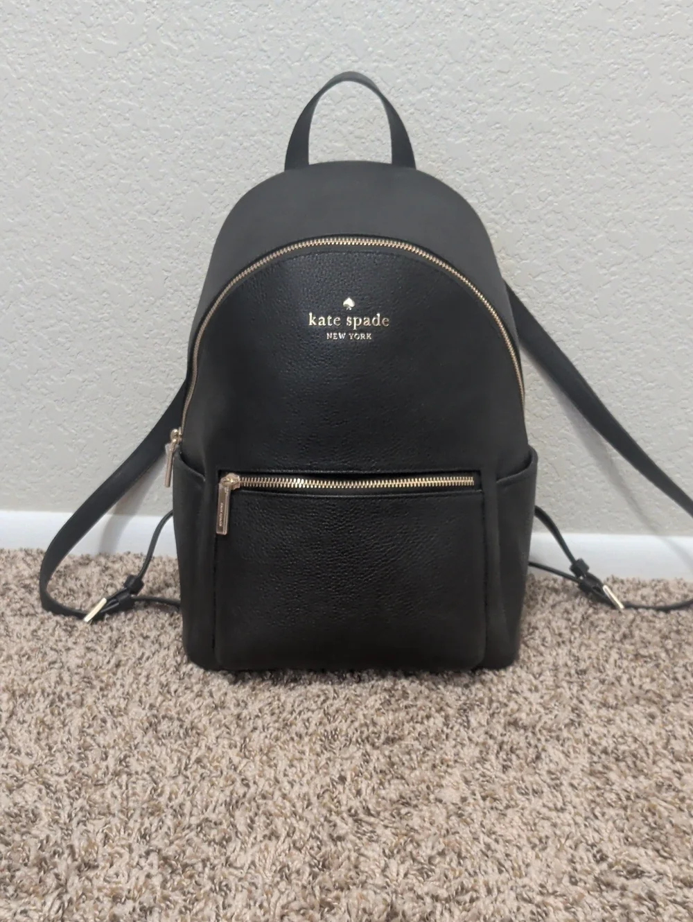 Kate Spade Leila black pebbled leather medium dome backpack with gold hardware